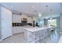 Modern kitchen with white cabinets, an island, and stainless steel appliances at 2406 High Tides Way, Wesley Chapel, FL 33543