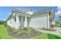 House exterior showcasing a walkway, landscaping, and a charming front entrance at 2613 Star Apple Way, Sarasota, FL 34240