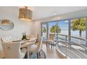 Elegant dining area with water views and modern light fixture at 4950 Bayshore Blvd # 23, Tampa, FL 33611
