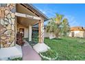 One-story house with stone facade and covered entryway at 7022 Arbor View Ln, New Port Richey, FL 34653