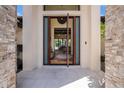 Grand entrance featuring a large wooden door and a glimpse into the home's elegant interior at 9276 Starry Night Ave, Sarasota, FL 34241