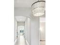 Bright and airy entryway with tile flooring and a stunning light fixture at 12818 Boggy Creek Dr, Riverview, FL 33579