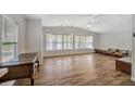 Large living room featuring hardwood floors and ample natural light at 109 N Saint Thomas Cir, Apollo Beach, FL 33572