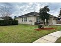 Side view of house with grassy yard and walkway at 4240 Hawksley Pl, Wesley Chapel, FL 33545