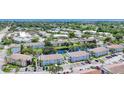 Aerial view of community with pond, tennis court, and various buildings at 3865 59Th W Ave # 4190, Bradenton, FL 34210