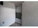 Front door entrance with storm door and tiled flooring at 8818 Bay Pointe Dr # 108, Tampa, FL 33615