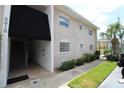 Building exterior showcasing entrance, landscaping, and walkway at 8818 Bay Pointe Dr # 108, Tampa, FL 33615