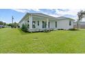 Spacious backyard with covered patio and lush greenery at 6999 Burnsville St, Englewood, FL 34224