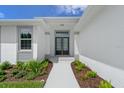 Inviting entryway with double doors and lush landscaping at 6999 Burnsville St, Englewood, FL 34224