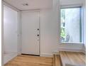 Light and airy condo entryway with wood floors and built-in bench at 1028 Apollo Beach Blvd # 4, Apollo Beach, FL 33572