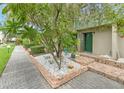 Condo unit's front entrance with landscaping and walkway at 1028 Apollo Beach Blvd # 4, Apollo Beach, FL 33572