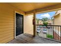 Private condo entrance with a wooden deck and view of the parking lot at 8638 Fancy Finch Dr # 201, Tampa, FL 33614