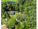 Beautiful aerial view of home with lush surroundings, dock and lake at 4617 John Moore Rd, Brandon, FL 33511