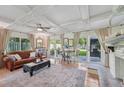 Inviting living room with a coffered ceiling, fireplace, and French doors to outdoor space at 608 Armada S Rd, Venice, FL 34285