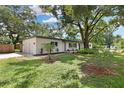 Ranch home with a large yard and mature trees at 302 Springdale Pl, Temple Terrace, FL 33617