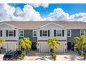 Three-unit townhome building with gray siding and a shared driveway at 6633 Serenity Fall Ln, Sarasota, FL 34240