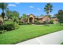 Home exterior with lush landscaping and palm trees at 824 Citrus Wood Ln, Valrico, FL 33594