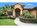 Front view of home with manicured landscaping and walkway at 824 Citrus Wood Ln, Valrico, FL 33594