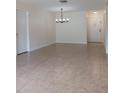 Spacious living room with tile floors and chandelier at 4606 W Gray St # 110, Tampa, FL 33609