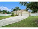 Two-story house with a two-car garage and nicely landscaped yard at 1704 Cresswell Manor Ct, Dover, FL 33527
