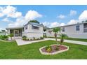 Landscaped manufactured home with a covered porch and spacious yard at 122 E Saint Annes Cir, Apollo Beach, FL 33572