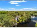 Aerial view of a modern home nestled in lush greenery with waterfront access at 321 W Hanlon St, Tampa, FL 33604