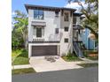 Contemporary two-story home showcasing a modern design, attached garage, and manicured front yard at 321 W Hanlon St, Tampa, FL 33604