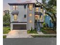 Modern two-story home boasts a sleek design with large windows and well-lit entry at 321 W Hanlon St, Tampa, FL 33604
