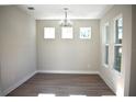 Bright dining room featuring hardwood floors, ample natural light, and contemporary chandelier at 759 48Th N Ave, St Petersburg, FL 33703