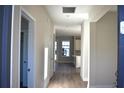 Inviting entryway featuring light hardwood floors, neutral walls, and views into the kitchen at 759 48Th N Ave, St Petersburg, FL 33703