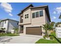 Contemporary two-story home featuring a two-car garage and landscaped front yard at 2206 N Boulevard, Tampa, FL 33602