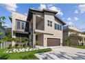Modern two-story home with a balcony, two-car garage, and landscaped front yard at 2206 N Boulevard, Tampa, FL 33602