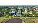 Aerial view of waterfront homes with pools and lush landscaping near the marsh at 4031 Eagle Nest Dr, Hernando Beach, FL 34607