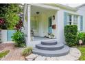 Inviting front porch with steps and a light fixture, offering curb appeal at 1411 E Powhatan Ave, Tampa, FL 33604