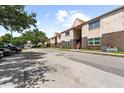 Apartment building exterior with parking and landscaping at 9009 Westchester Cir # B-18, Tampa, FL 33604
