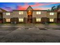 Evening view of a two-story apartment building with brick and stucco at 9009 Westchester Cir # B-18, Tampa, FL 33604