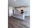 Modern kitchen with a large island, stainless steel appliances, and granite countertops at 18146 Beach Ranch Ter, Lakewood Ranch, FL 34211