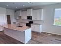 Bright kitchen featuring white cabinets, a granite island, and stainless steel appliances at 18146 Beach Ranch Ter, Lakewood Ranch, FL 34211