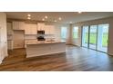 An open concept kitchen with granite countertops, stainless appliances and hardwood floors at 18146 Beach Ranch Ter, Lakewood Ranch, FL 34211