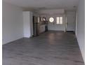 Bright and spacious living area with gray vinyl flooring and an open floor plan at 1433 S Belcher Rd # A8, Clearwater, FL 33764