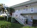 Two-story building with stairs and lush landscaping at 1433 S Belcher Rd # A8, Clearwater, FL 33764
