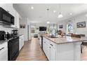 Spacious kitchen with white cabinets, granite countertops, stainless steel appliances, and an open layout at 10744 Hawks Landing Dr, Land O Lakes, FL 34638