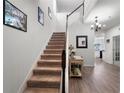 Bright foyer with staircase, hardwood floors, and decorative accents at 10744 Hawks Landing Dr, Land O Lakes, FL 34638