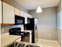 Kitchen with stainless steel appliances and light wood cabinets at 6410 Cypressdale Dr # 201, Riverview, FL 33578
