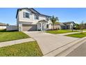 Two-story house with driveway and landscaped yard at 3172 Lytton Hall Dr, Zephyrhills, FL 33540