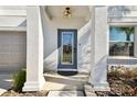 Modern front door with glass panels and stone accents at 3172 Lytton Hall Dr, Zephyrhills, FL 33540