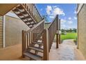 Wooden staircase leading to condo with scenic backyard view at 9481 Highland Oak Dr # 1615, Tampa, FL 33647