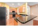 Modern kitchen with granite countertops and wood cabinets at 10741 Rockledge View Dr, Riverview, FL 33579