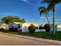 Side view of a white single story home with lush landscaping at 9870 36Th N Way # 4, Pinellas Park, FL 33782