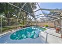 Inviting kidney-shaped pool with screened enclosure, providing a private oasis at 17721 Ridgeway Point Pl, Tampa, FL 33647
